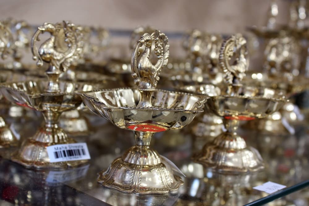 Brass dragon statues displayed on a glass store shelf. 