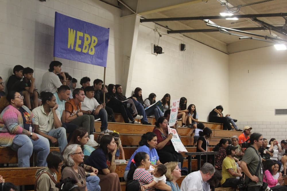 People sit on bleachers in a crowd