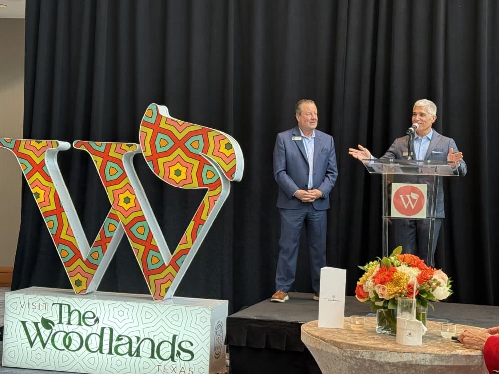 two people speak at a podium