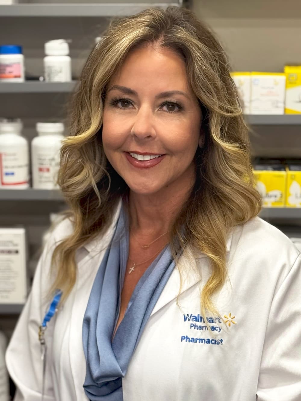 Shantay Peloquin stands within a Walmart pharmacy.