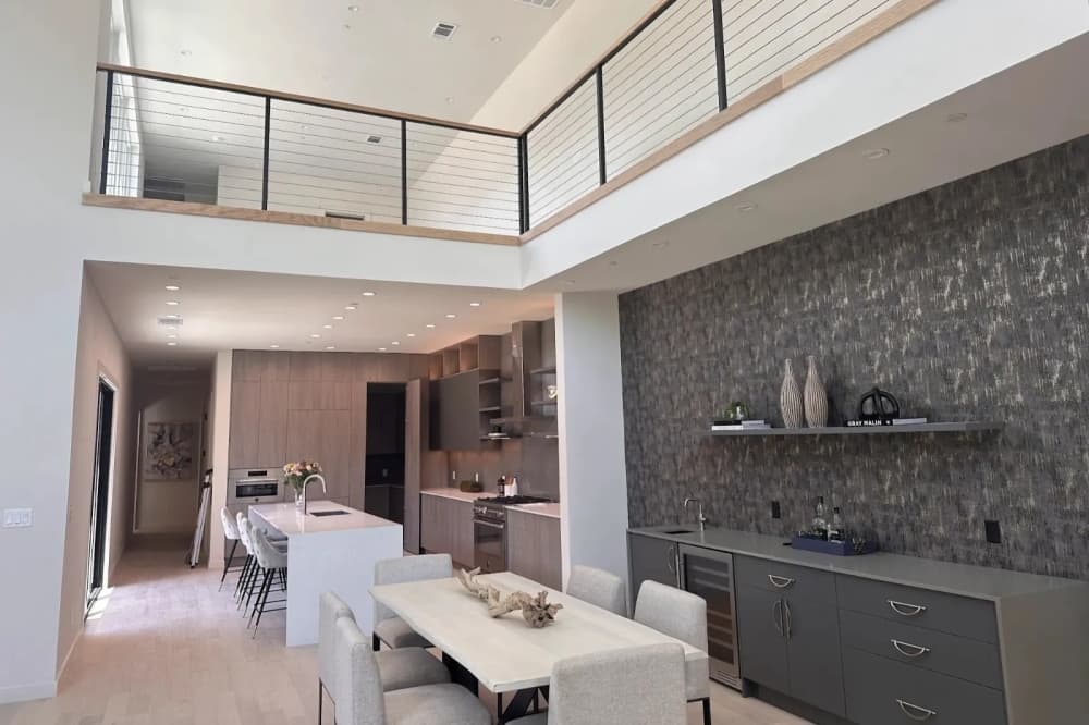 A dining room and kitchen with an island in a townhome