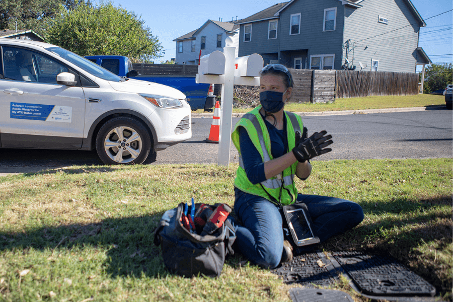 Person in grass who helps install leak detection system