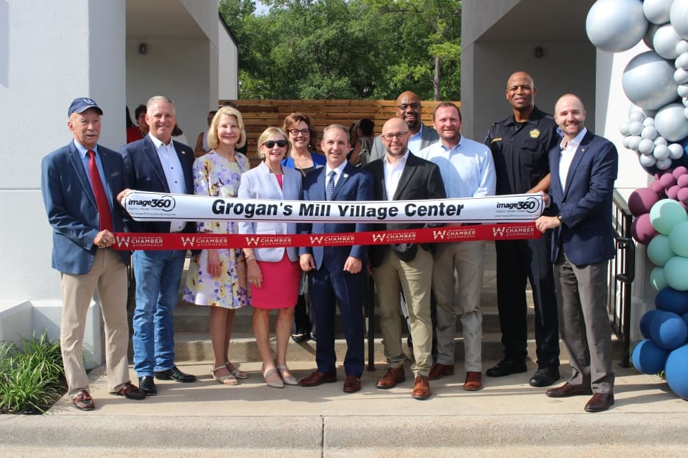 Members of The Woodlands Township Board of Directors and Montgomery County Precinct 3 Commissioner Ritch Wheeler's Office attended the ribbon cutting ceremony for the retail section of the Grogan's Mill Village Center June 25. (Jessica Shorten/Community Impact)