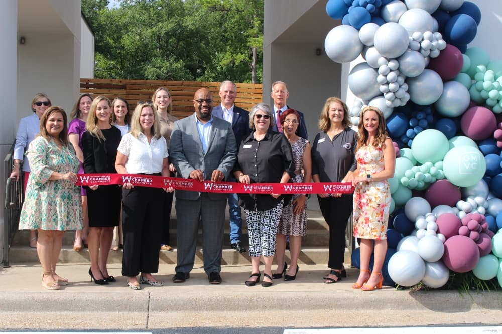 Representatives with The Woodlands Area Chamber attended the ribbon cutting ceremony for the retail section of the Grogan's Mill Village Center June 25. (Jessica Shorten/Community Impact)
