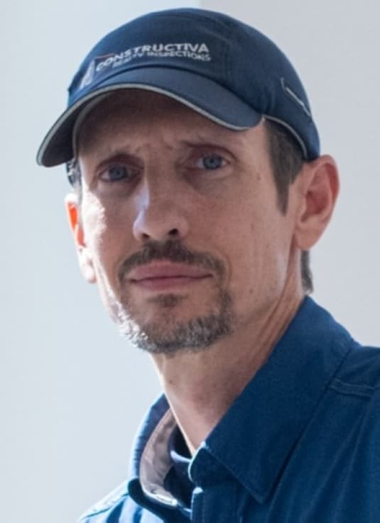 man in blue shirt and hat