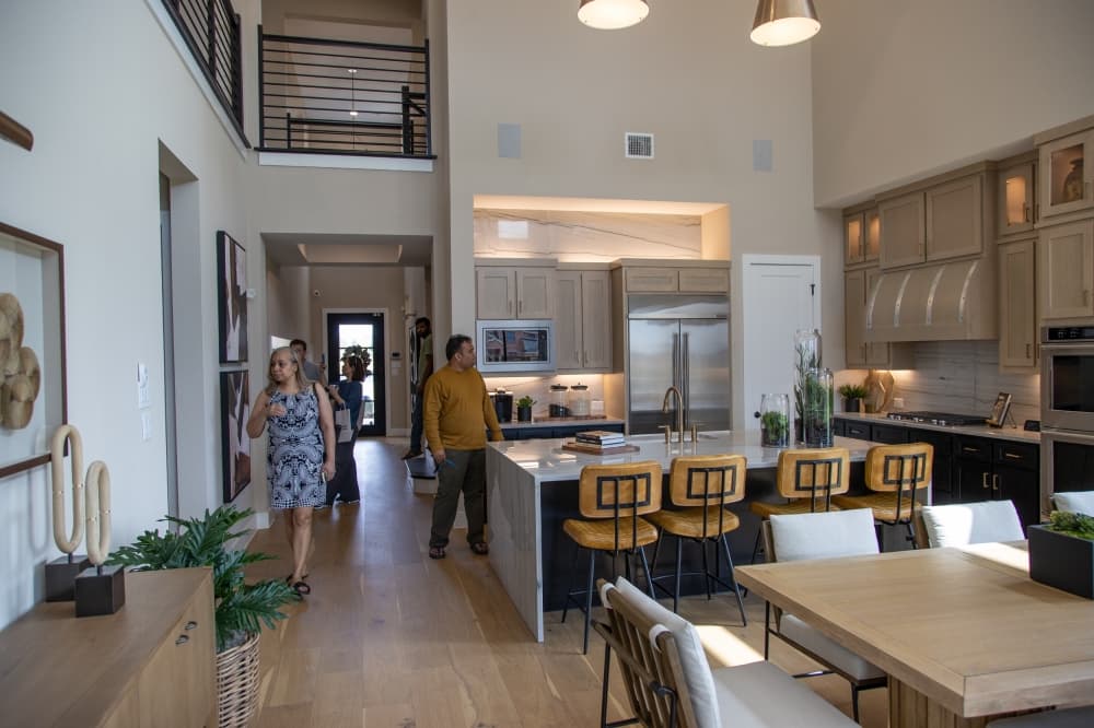 a group of people walk through a new house