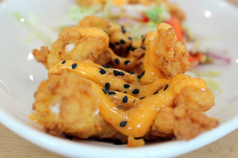 Fried shrimp topped with orange sauce. 