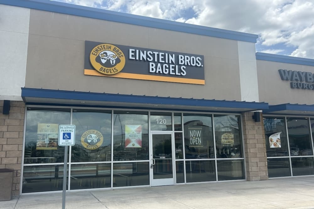 The exterior of an Einstein Bros. Bagels in Universal City, Texas is shown on a cloudy afternoon.