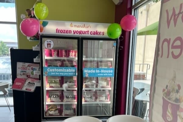 A fridge filled with frozen yogurt cakes.