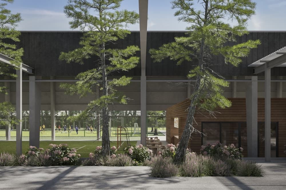 Two outdoor futsal courts with children playing in the background. The center is filled with trees.