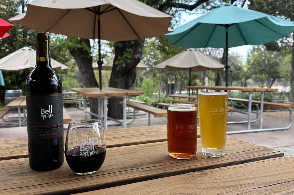 wine and beer glasses sit on a table