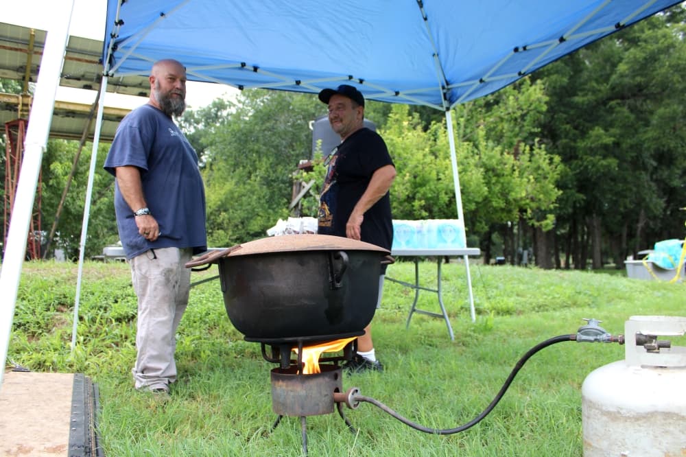 Jason Hale (left) with nonprofit Street Ministries 25:40 drove from Rockdale to Jonah the morning of July 7 to distribute food and water to residents in need. 