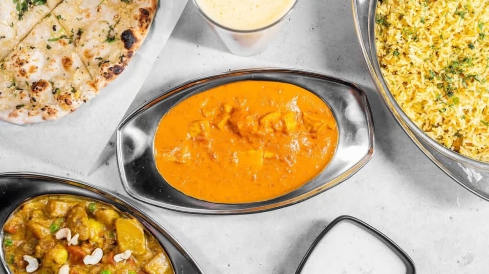 Overview of a variety of dishes one featuring orange sauce.