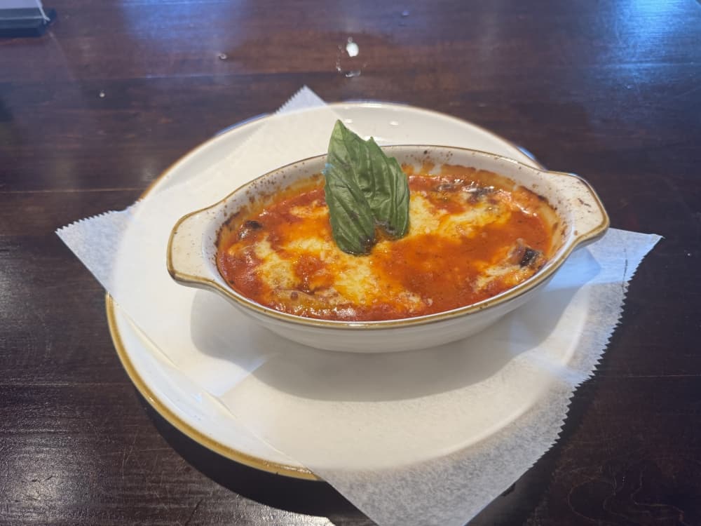 Lasagna in a white dish.