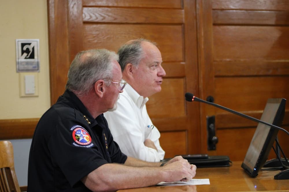 (From left) Williamson County Emergency Management Director Bruce Clements and Senior Director of Infrastructure Bob Daigh discuss FEMA programs and road updates county during a July 11 county commissioners meeting. 