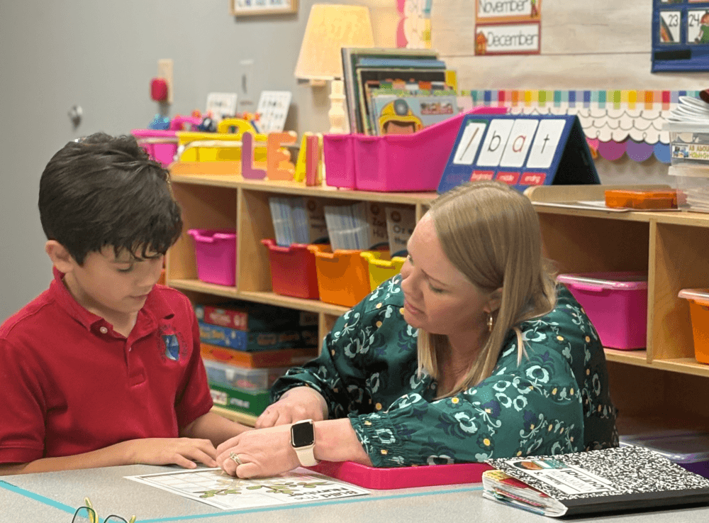 Teacher provides one-on-one instruction to an elementary student at The Met Christian Academy in Tomball, emphasizing individualized support and academic excellence.