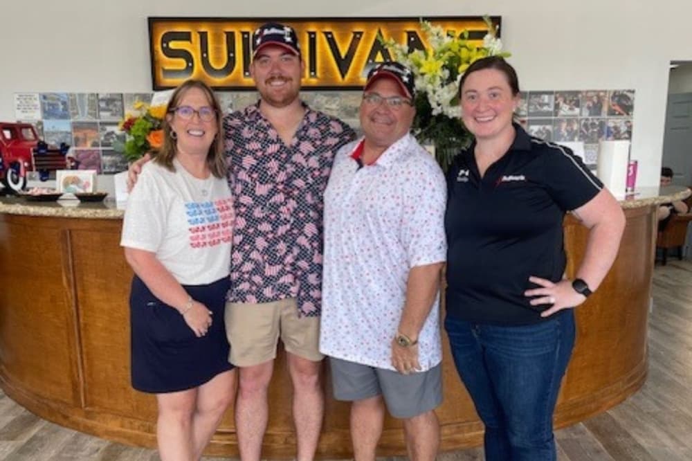 Owner Michael Sullivan, CEO Danny Sullivan, business development employee Kelly Sullivan and Geralyn Sullivan stand together. The shop celebrated its 40th anniversary in June. (Courtesy Sullivan's Trucks, Auto and Collision)