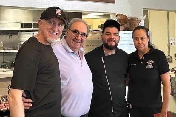 From left, owner Willie Stewart stands with Rocco Sofio, Javier Muniz and Muniz's wife, Martha, in the kitchen of Rocco's. (Courtesy Willie Stewart)