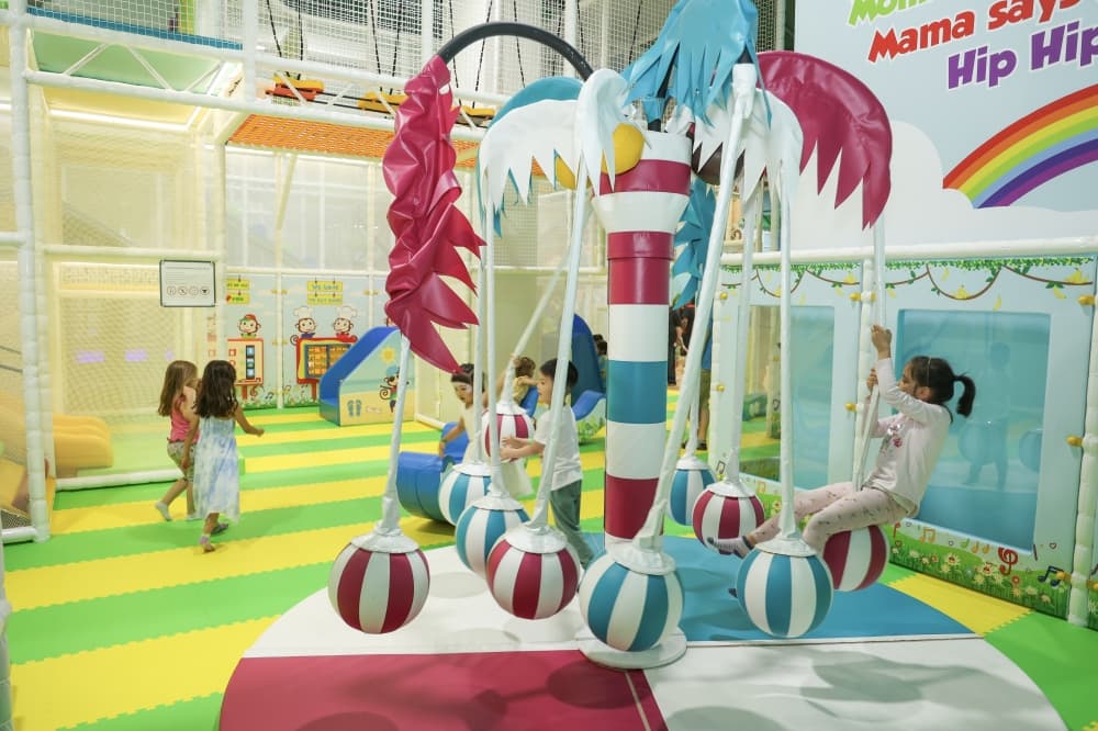 A child swings on a playground activity at a Cheeky Monkeys location.
