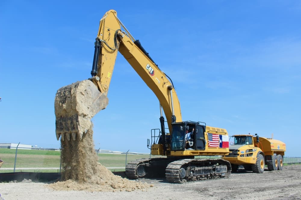 Construction equipment pouring dirt