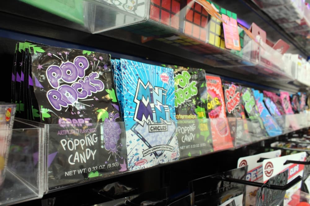 Rows of candy with Pop Rocks candy in the foreground. 