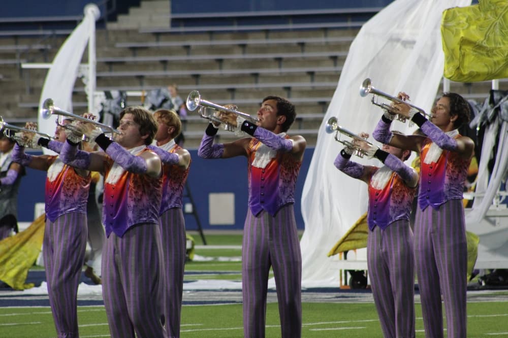 Members of the Academy Drum and Bugle Corps play their instruments during the DCI McKinney event held July 21 at McKinney ISD Stadium.