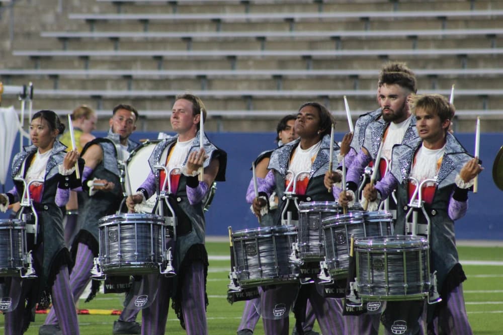 Members of The Academy Drum and Bugle Corps play percussion instruments during the DCI McKinney event held July 21 at McKinney ISD Stadium.