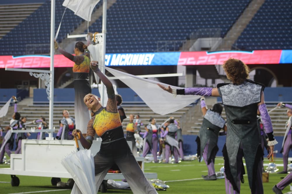 Members of The Academy Drum and Bugle Corps play percussion instruments during the DCI McKinney event held July 21 at McKinney ISD Stadium. 