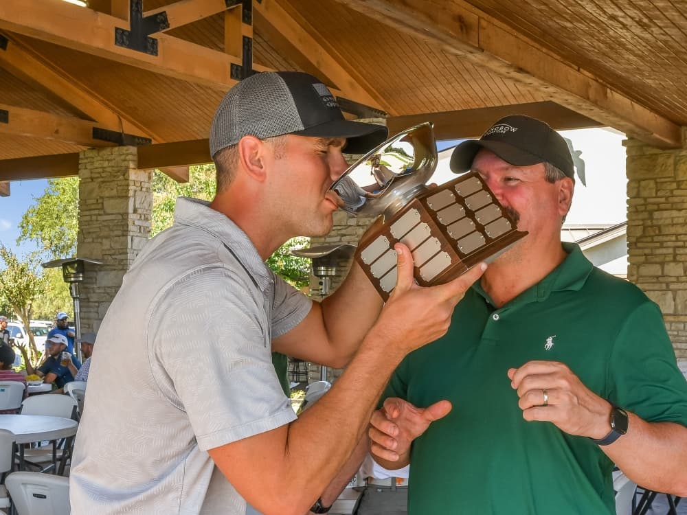 man drinking from trophy 
