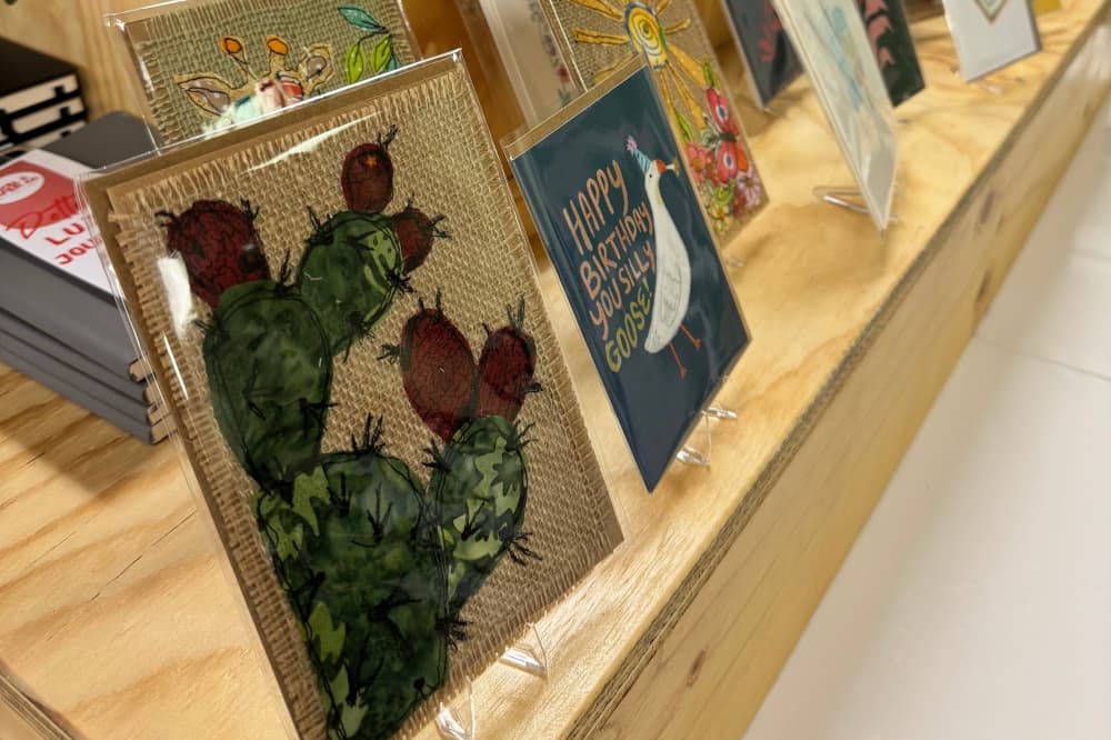 Artistic greeting cards wrapped in protective plastic sleeves. 