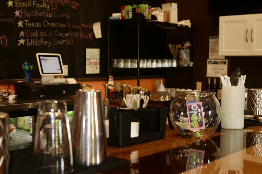 Image of the bartop with the register and bar tools in frame 