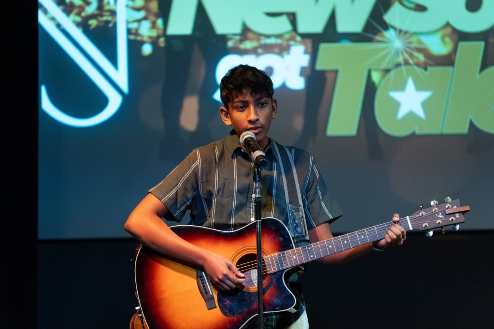 a kid playing the guitar