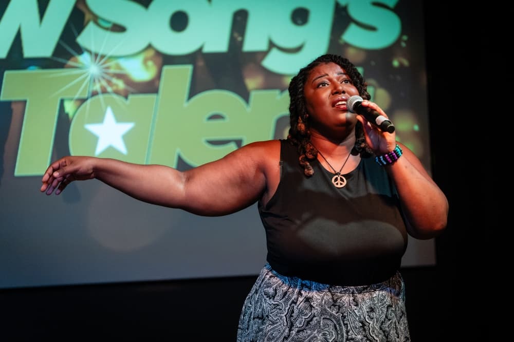 a person singing on a stage