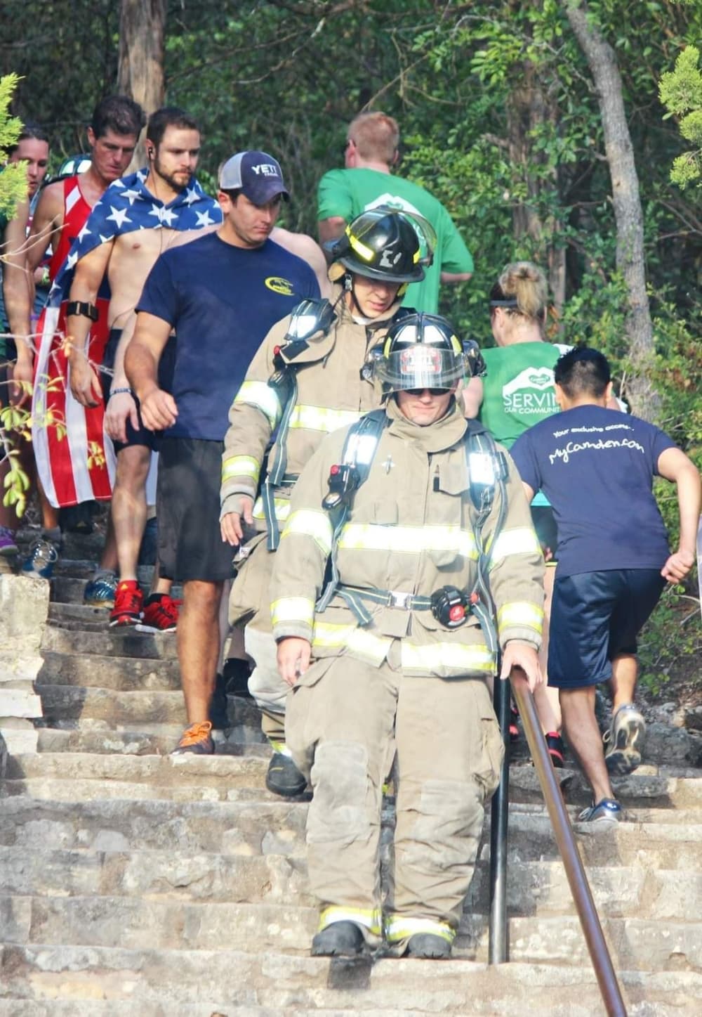 An image from a previous year's event with firefighters walking down the trail steps. 