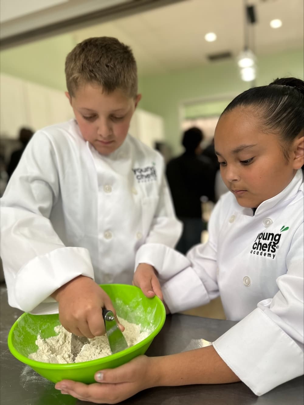 Students will start with a white chef's jacket, and can work up to a black chef's jacket and the title of Young Chefs Academy MasterChef. (Courtesy Young Chefs Academy)