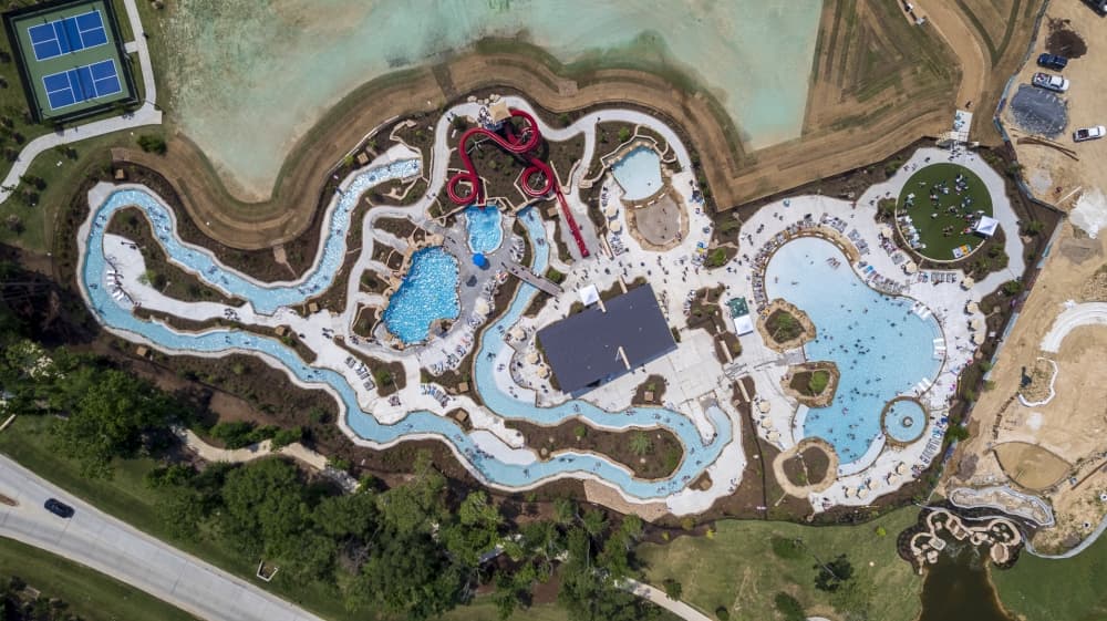 Families explore model homes and water park amenities at Discovery Cove during the All Trails Lead Home tour.