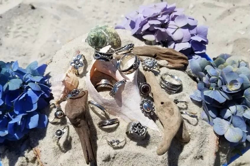 rings and earrings on sand