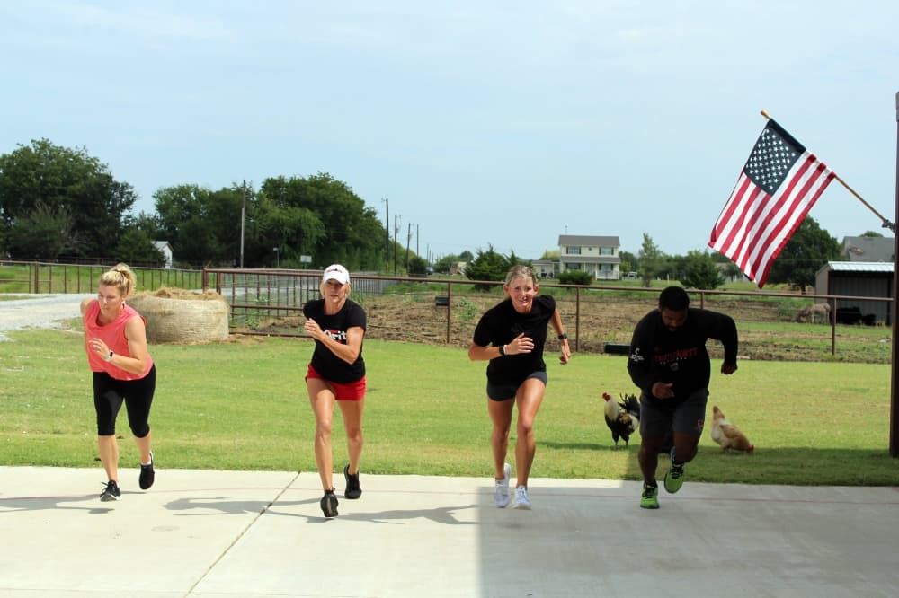 Three females and one male running outside.