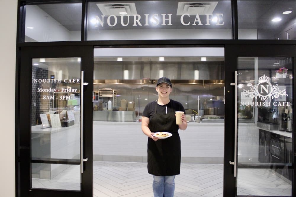 general manager in front of establishment 