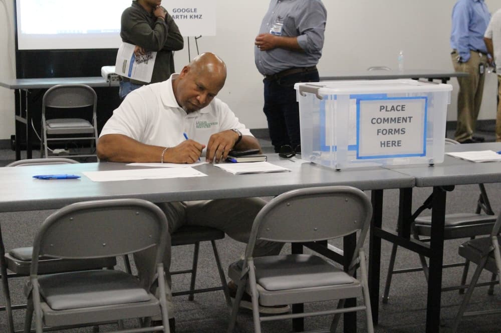 a man signs papers at a table