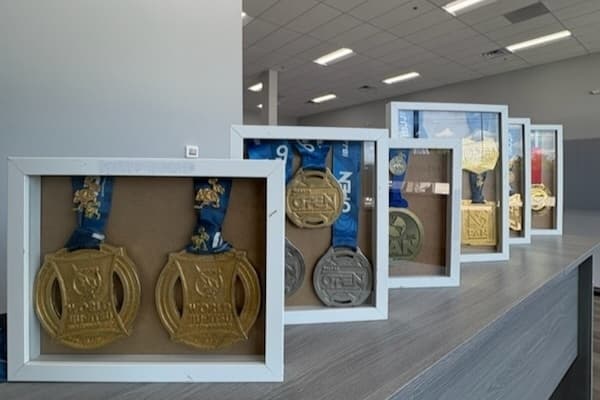 Medals are displayed in the interior of the JRoots Academy facility