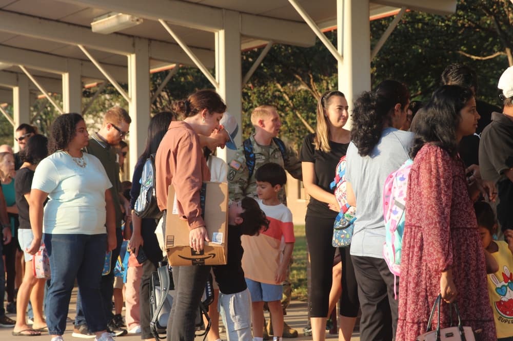 Students wait with their parents to check in on the first day of school. (Brooke Sjoberg/Community Impact)
