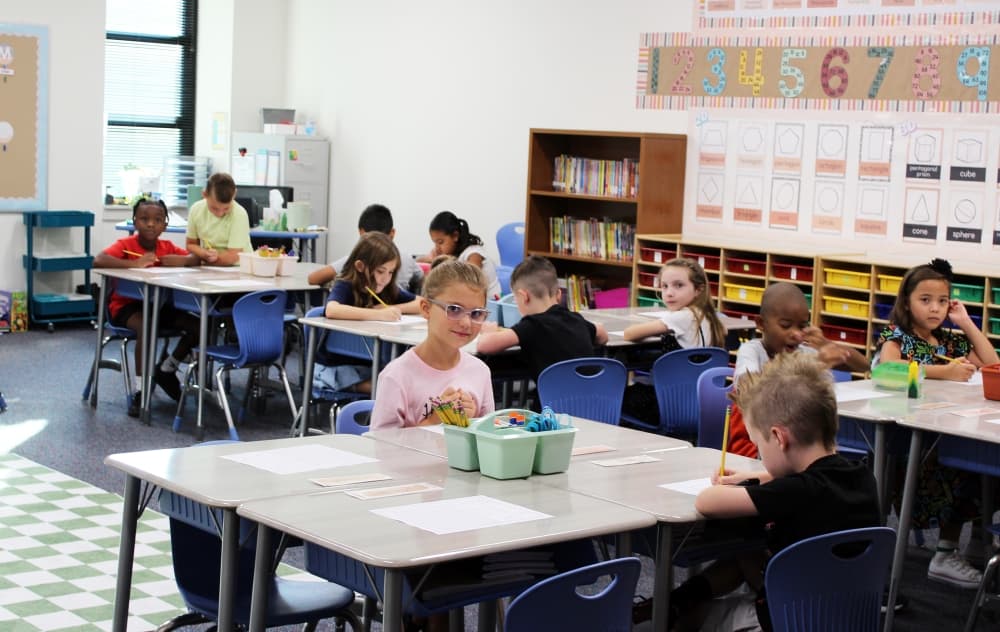 Students working at tables. 