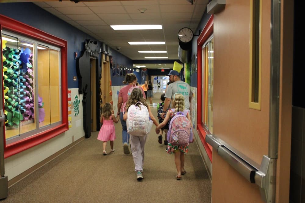 Two KISD students walking hand in hand
