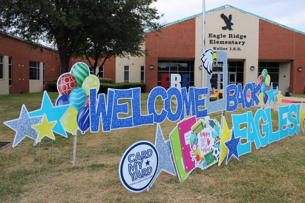A paper cutout that says, "Welcome back, eagles!"