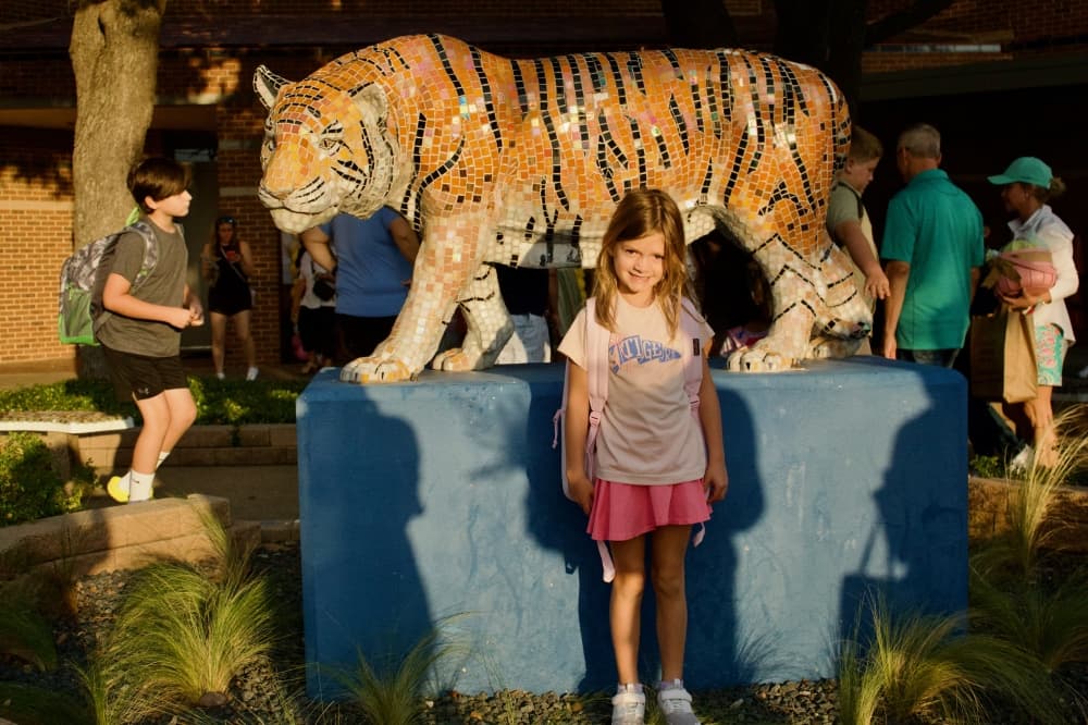  A student poses in front of the O C Taylor's mascot. (Heather McCullough/Community Impact)