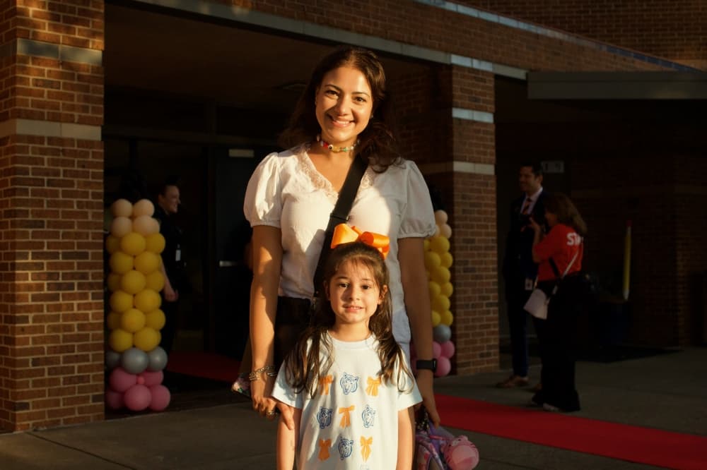 A parent and student pose for a photo on the first day of school.  (Heather McCullough/Community Impact)