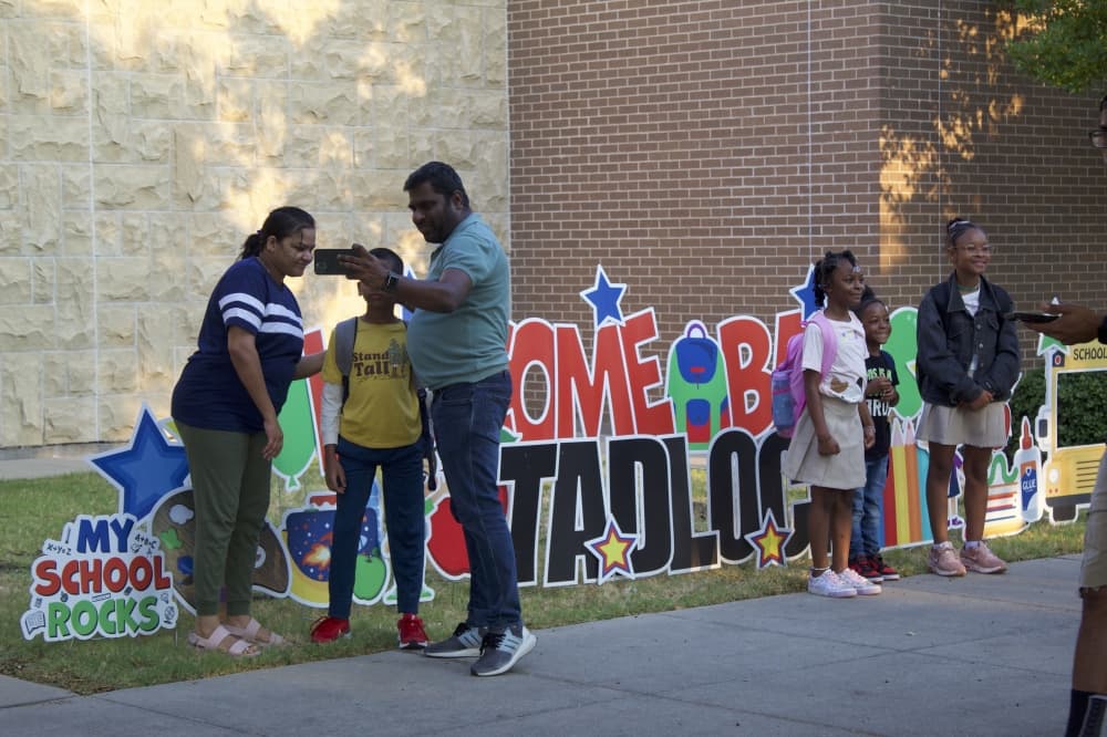 Parents take a selfie with their child ahead of the first day of school at Tadlock Elementary on Aug. 13. (Samantha Douty/Community Impact)