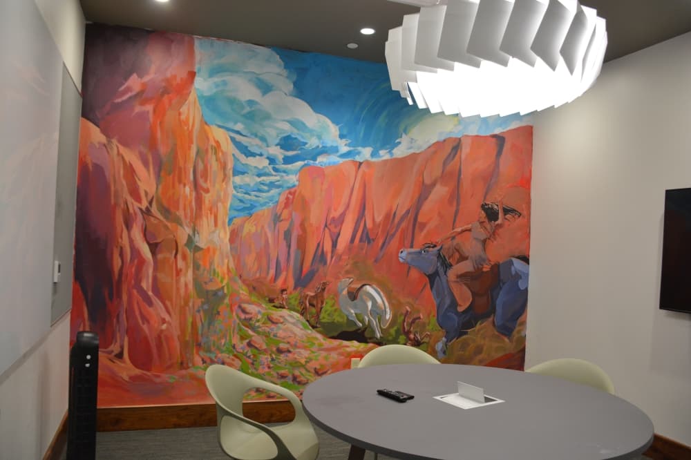 Soun Reddy's painted a Panhandle Plains mural within one of the library's study rooms.Murals painted by five Flower Mound High School students were honored at a ribbon cutting ceremony Aug. 12.  Library officials recognized the students and gave them the opportunity to share details about their work, which represents different landscapes across Texas.  The details The students worked on their paintings throughout the summer, said Director of Library Services Rachel Hadidi. All five students chose a different Texas-themed landscape, including: Gael Giovani Guardado’s Piney Woods-inspired mural Noah Kang’s Gulf Coast-inspired mural Rhianna Patel’s lake-inspired mural Soun Reddy’s Panhandle plains-inspired mural Abbie Sweatt’s Big Bend Country-inspired mural Hadidi said some anonymous donors helped donate paint for the murals.  “I really love art, and this was a way to bring it into the community,” she said.  What they’re saying Mayor Cheryl Moore said bringing in the artists to paint murals was a good addition to the library.  “Adding things like new and interesting art incorporates what we're all about with the cultural arts here in the community,” Moore said.  Hadidi added that with the library’s visitors, it adds exposure for the artists and also creates a place where the public can come view art.  “We don't have an art center,” Hadidi said. “You can't go anywhere to just see art, and so you come and see it in the library.”  What’s next In the future, Hadidi said library staff may try to expand the opportunity for Marcus High School students to paint the remainder of the study rooms.