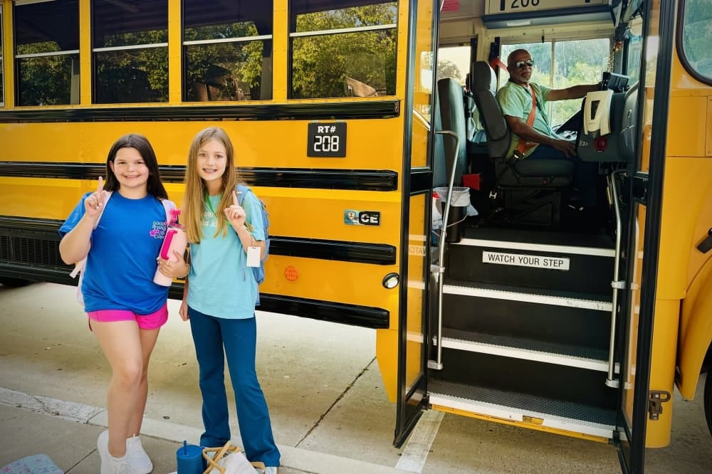students next to a bus